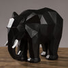 Statue elephant noir posee sur un meuble en bois